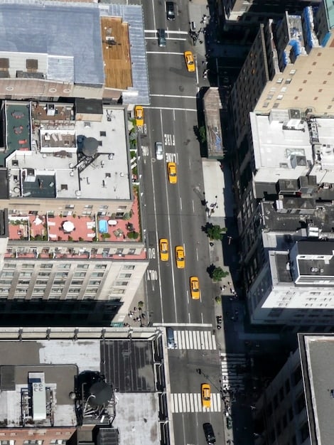 A bird's-eye view of a modern city intersection with self-driving cars, intelligent traffic lights, and designated lanes for bikes and pedestrians, illustrating advanced urban mobility.