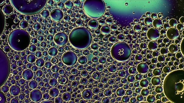 A detailed microscopic view of engineered biological cells forming intricate patterns on a substrate, representing bio-inspired material synthesis.
